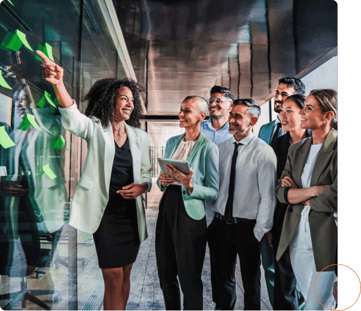 Team collaborating with sticky notes on glass.