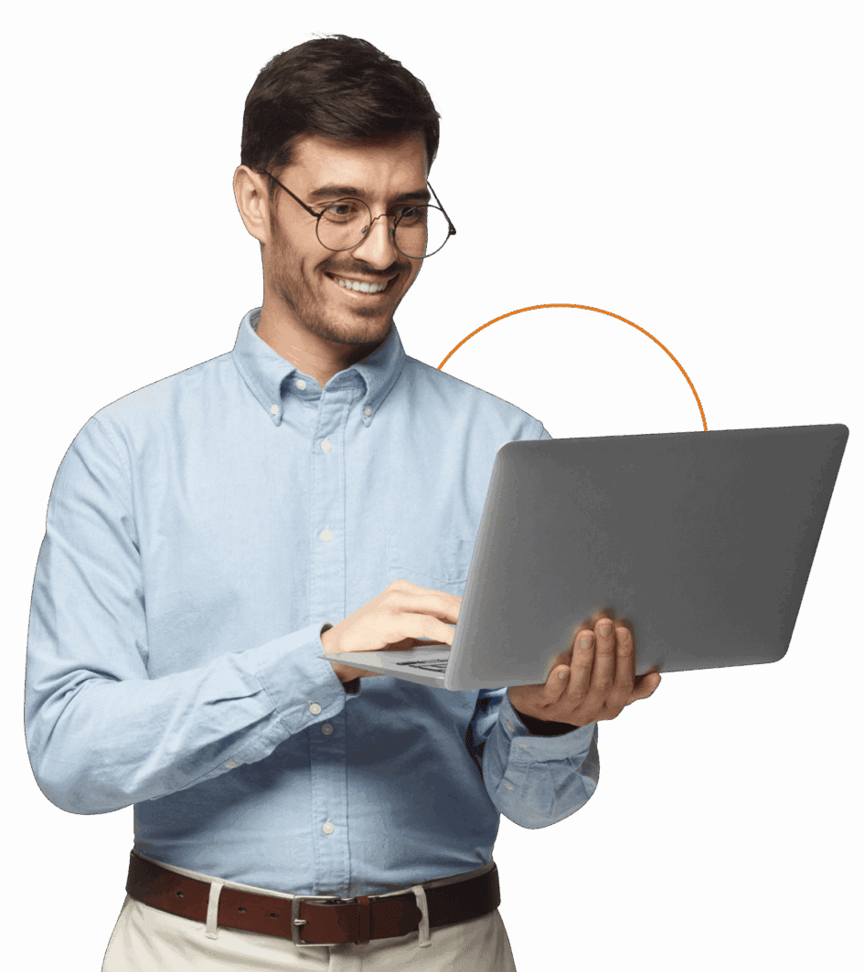 Man smiling while using a laptop.